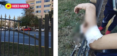 Üst geçitti kullanmaya üşenince…  Kolu demir korkuluklara saplandı